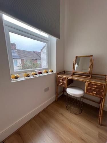 a room with a desk and a window with stuffed animals at 2025 Award Winner Liverpool Cherry House - 4 Bedrooms in Liverpool