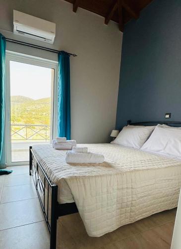 a bedroom with a large bed with towels on it at Saladi Beach House in Didyma