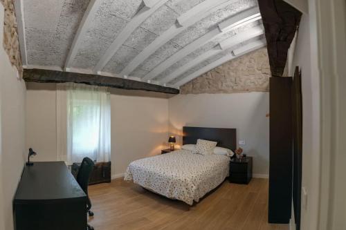 a bedroom with a bed and a coffered ceilings at Casa rural Villa Cardil en la entrada del parque Cabarceno in Obregon