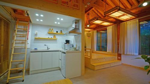 a kitchen with a ladder and a sink in a room at Naru Hanok stay in Jeonju