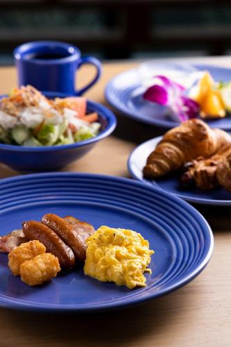 a table with plates of food on a table at ibis Styles Nagoya in Nagoya