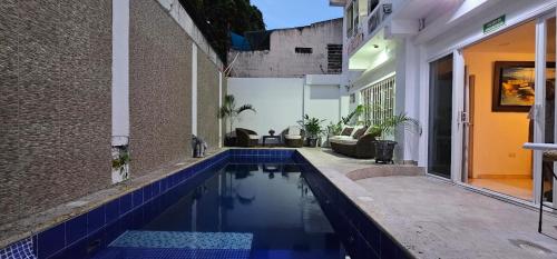 a swimming pool in the middle of a house at Caribean Vacation Home in Cartagena de Indias
