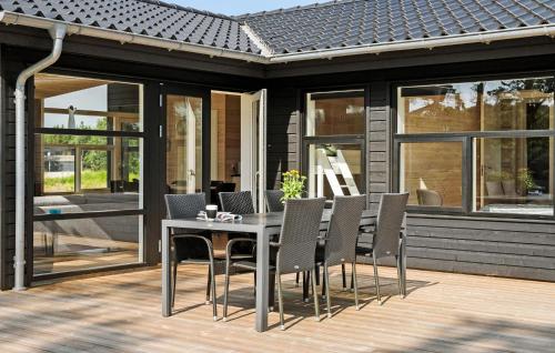 a dining table and chairs on a patio at 3 Bedroom Cozy Home In Ejstrupholm in Krejbjerg