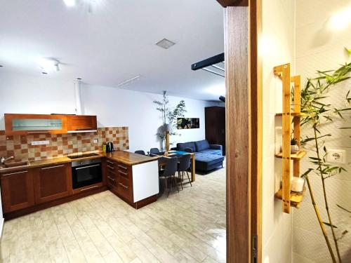 a kitchen and a living room with a table at Caesar Residence in Budapest