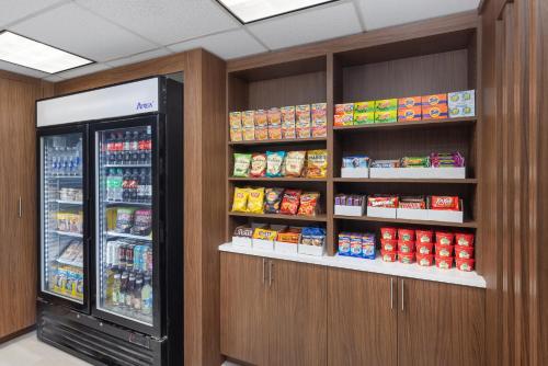 a store with a refrigerator and shelves of food at Holiday Inn Express Portland South - Lake Oswego by IHG in Lake Oswego
