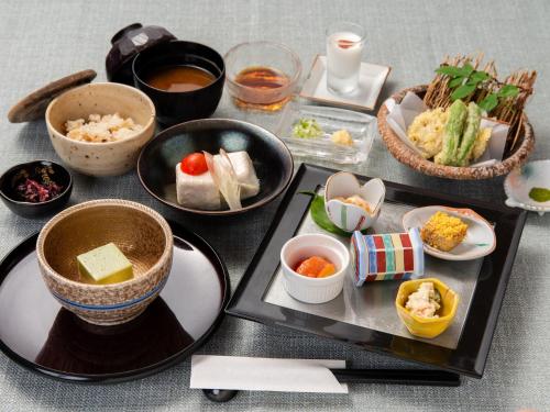 a table topped with bowls and plates of food at Togakubo in Isehara
