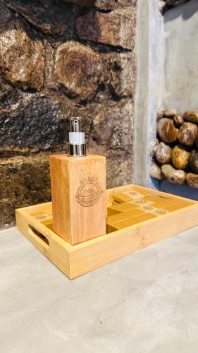 a wooden box with a bottle on a table at The Symbol of Ella in Ella