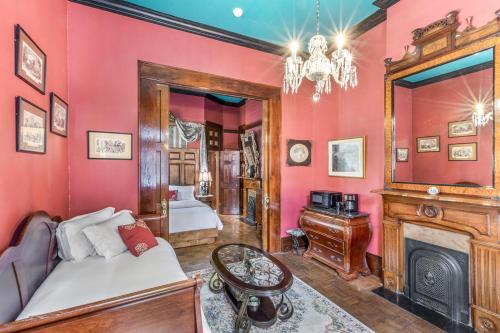 a bedroom with a bed and a fireplace at Royal Barracks Guest House in New Orleans