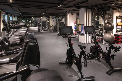 a gym with a bunch of bikes and treadmills at The Bidwell Marriott Portland in Portland