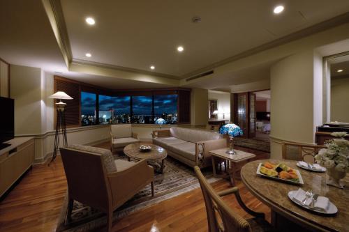 a living room with a couch and a table at The Naha Terrace in Naha