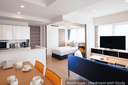 a living room with a room with a bed and a kitchen at Oakwood Apartments Nishi-Shinjuku Tokyo in Tokyo