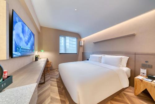 Postel nebo postele na pokoji v ubytování True Go Hotel Shanghai Xujiahui
