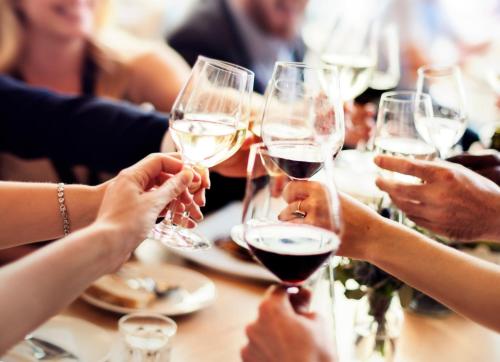 a group of people sitting around a table drinking wine at Crowne Plaza Changi Airport by IHG in Singapore