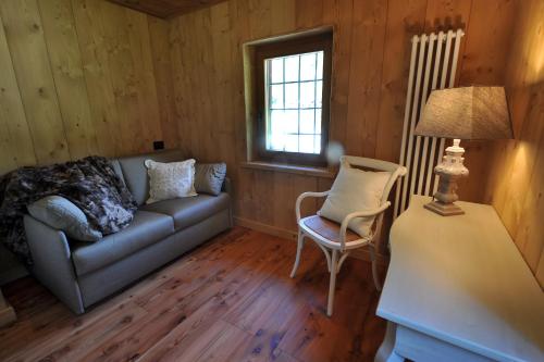 a living room with a couch and a chair at Historic Residenze Loo Bach in Gressoney-Saint-Jean