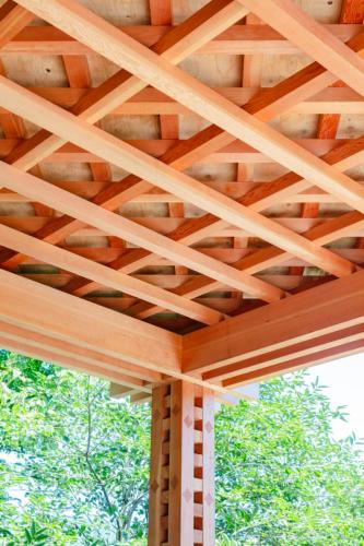 a wooden roof on a porch with trees in the background at GOURA TERRACE in Gora