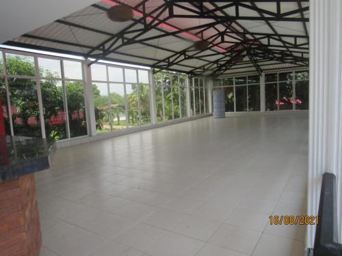 a large empty room with a white floor and windows at Quinta de san pedro in Villavicencio
