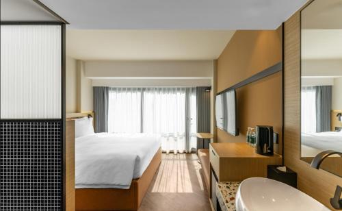 Postel nebo postele na pokoji v ubytování Mia Hotel - Shanghai Xuhui Jiaotong University