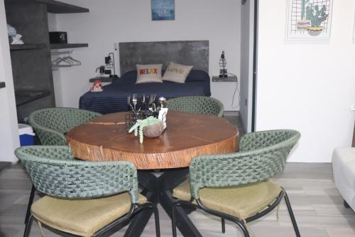 a dining room table with chairs and a bed at Las 3 Carabelas BCS in El Sargento