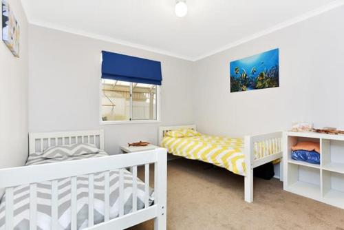 a white room with two beds and a window at 91 On the Rocks 91 Port Elliot Rd Hayborough Chiton - No Linen Included in Hayborough