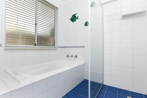 a white bathroom with a shower and a tub at 91 On the Rocks 91 Port Elliot Rd Hayborough Chiton - No Linen Included in Hayborough