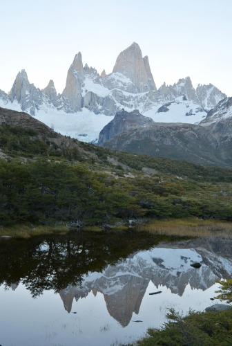 a mountain range with a reflection in a body of water at Hospedaje Mi Rincón El Chaltén in El Chalten