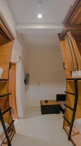 a room with two bunk beds in a room at DBeds Kuta Beach in Kuta