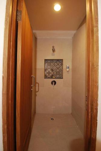 a hallway with a door and a picture on the wall at DBeds Kuta Beach in Kuta