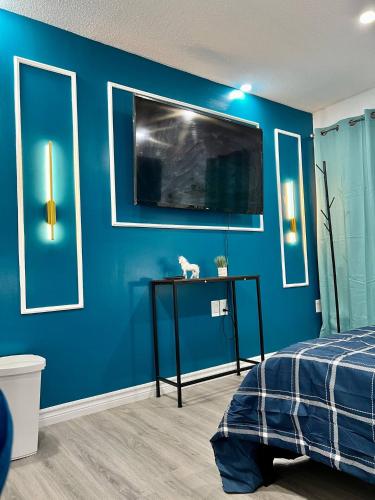 a bedroom with a blue wall with a cat on a table at Private Room Near Airport K4 in Mississauga