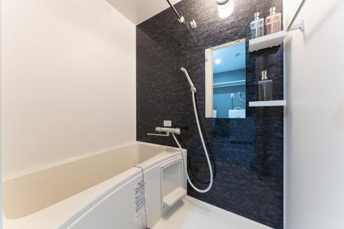 a bathroom with a shower and a sink at Omotenashi HOTEL Asakusa in Tokyo