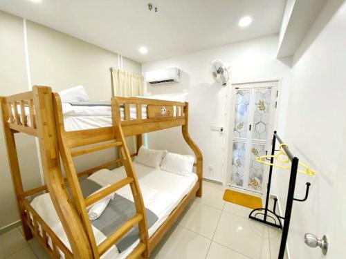 a bedroom with two bunk beds and a window at JOVIAL Modern Cozy Suite `Metropol BM BandarPerda in Bukit Mertajam