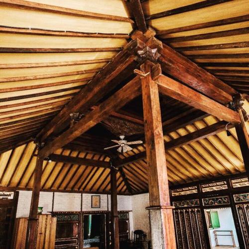 a wooden ceiling in a room with wooden beams at Joglo House in Central Bogor By penggemarlawas in Bogor