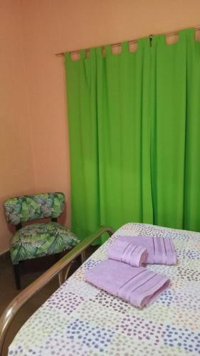 a hospital room with a bed and green curtains at Dani I in Jesús María