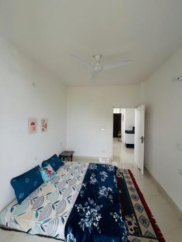 a bedroom with a bed and a ceiling fan at Dhyani Residence in Nakraunda