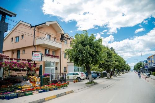 a street in a town with a building and flowers at Grand Cozy Apt Close to the Beach in Struga