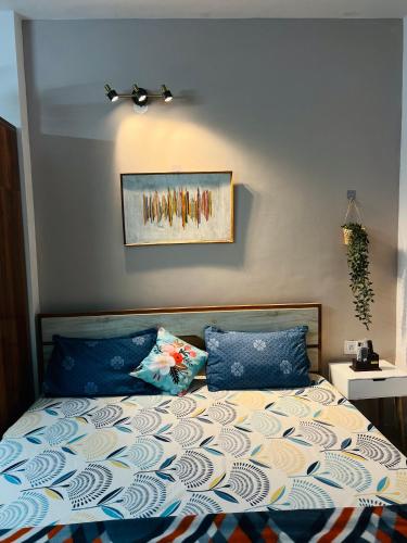a bed with two pillows and a picture on the wall at Dhyani Residence in Nakraunda