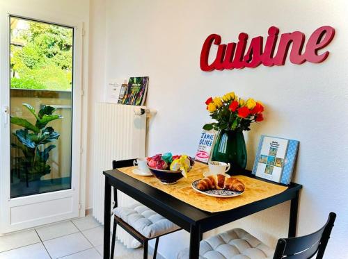 a table with a plate of food and flowers on it at Villa Sunshine - Lake Zurich Gold-Coast in Zollikon