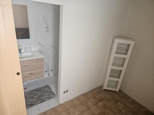 a bathroom with a sink and a towel ladder at CASA SANT`ANNA DI STAZZEMA in Culla
