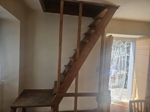 a wooden staircase in a room with a window at CASA SANT`ANNA DI STAZZEMA in Culla