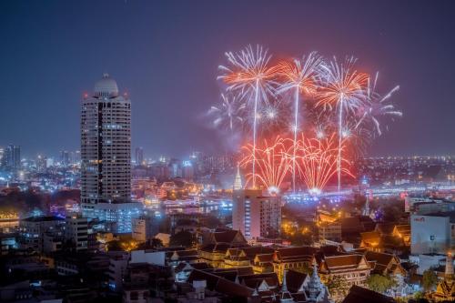a firework display in a city at night at Grand China Bangkok in Bangkok