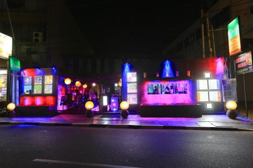 a city lit up at night with purple and blue lights at Randy's Seaview Studio in Negombo