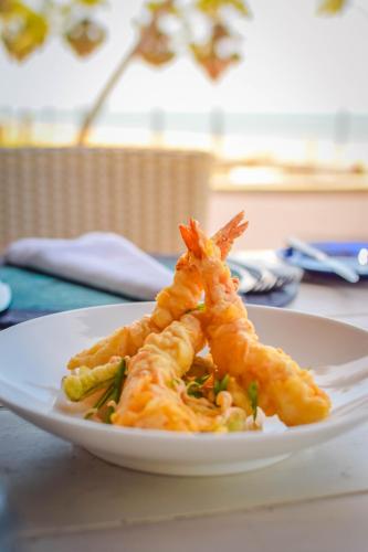 a plate of food with shrimp on a table at Jetwing Surf & Safari, A Luxury Reserve in Arugam Bay