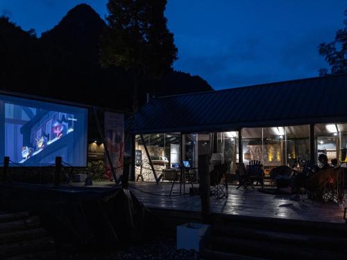a stage with a large screen at night at BZIKA Wonderland Retreat--Zhangjiajie National Forest Park Store in Zhangjiajie