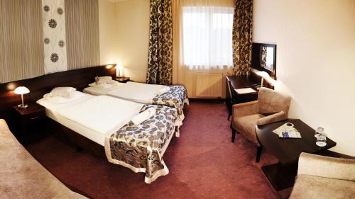 Ένα ή περισσότερα κρεβάτια σε δωμάτιο στο Hotel Rubbens & Monet