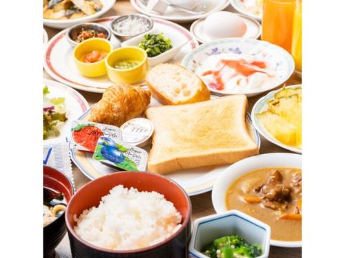 a table full of plates of food with rice and bread at Hotel Terrace The Square Hitachi - Vacation STAY 21919v in Hitachi