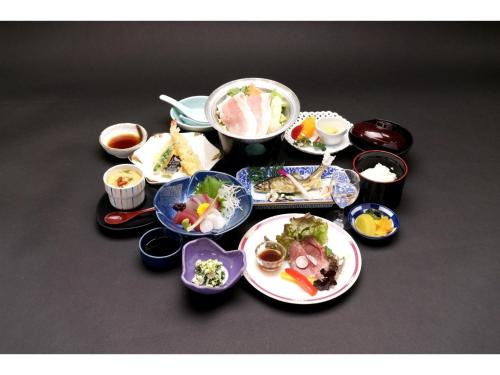 a group of plates and bowls of food on a table at Misato no Yu Kajikaso - Vacation STAY 22184v in Kimino