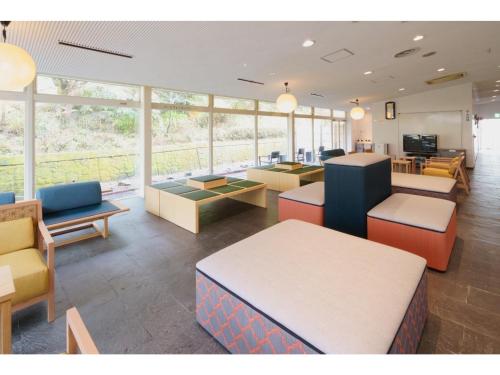 a waiting room with tables and chairs and windows at Misato no Yu Kajikaso - Vacation STAY 22184v in Kimino
