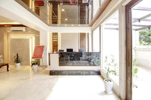 an empty lobby with a reception desk in a building at Marks Hotel & Banquet in Noida