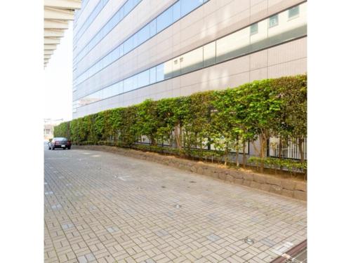 a building with a brick sidewalk in front of a building at Hotel Terrace The Square Hitachi - Vacation STAY 21902v in Hitachi