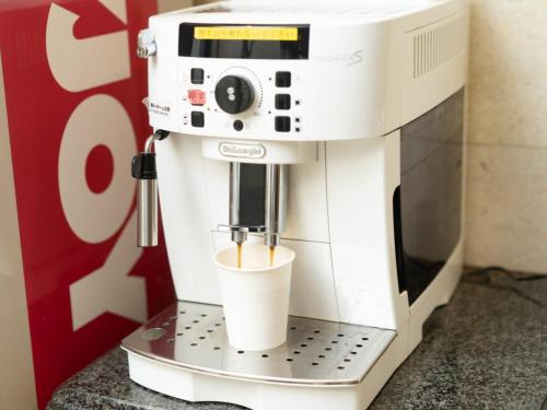 a coffee machine with a cup on a stand at Sun Hotel Tosu Saga - Vacation STAY 49476v in Tosu