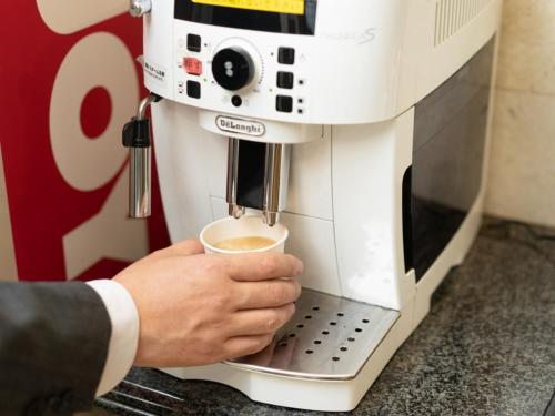 a man is holding a cup of coffee at Sun Hotel Tosu Saga - Vacation STAY 49476v in Tosu